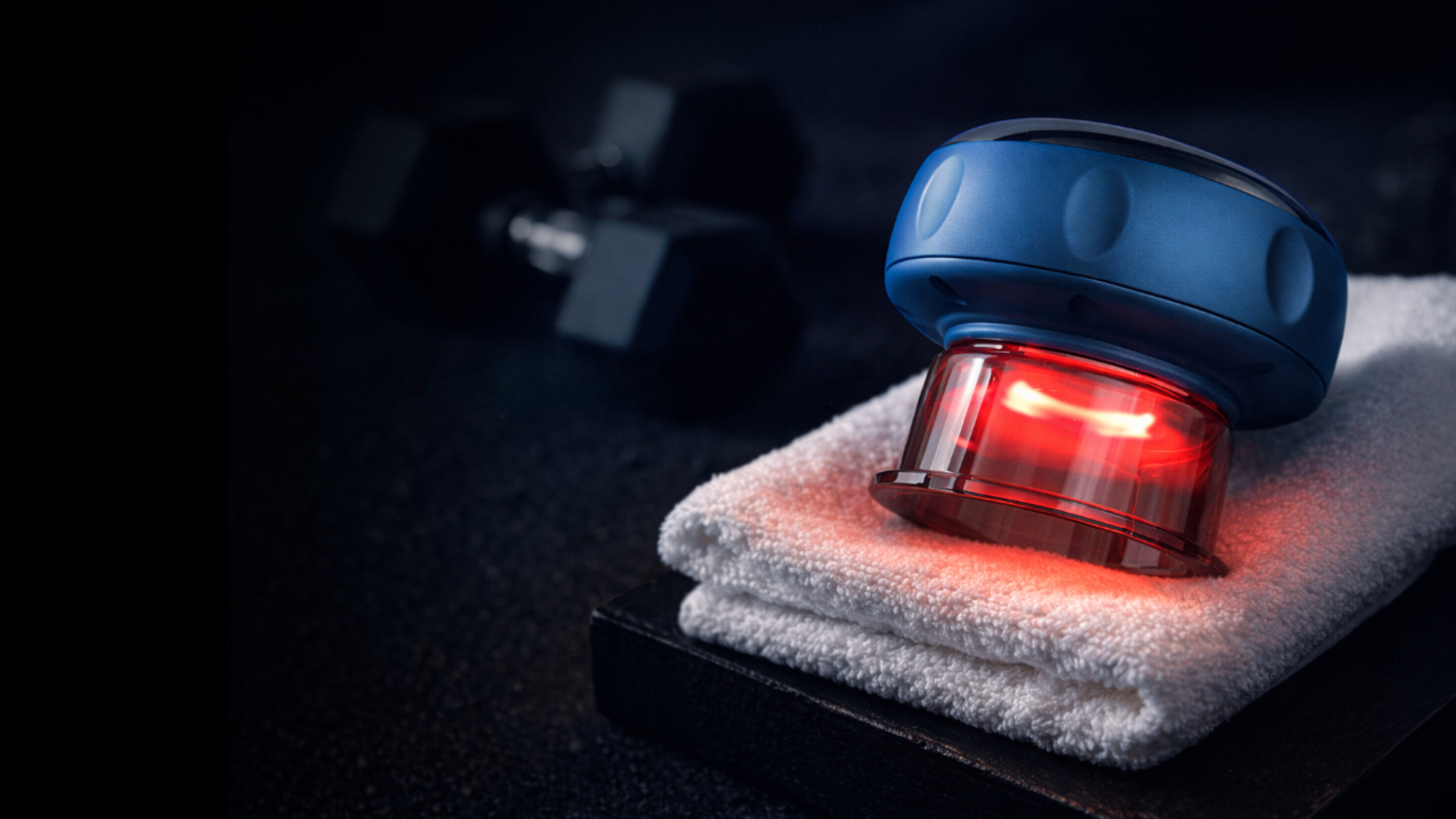 NuLYFF intelligent cupper laying on a towel with red light therapy